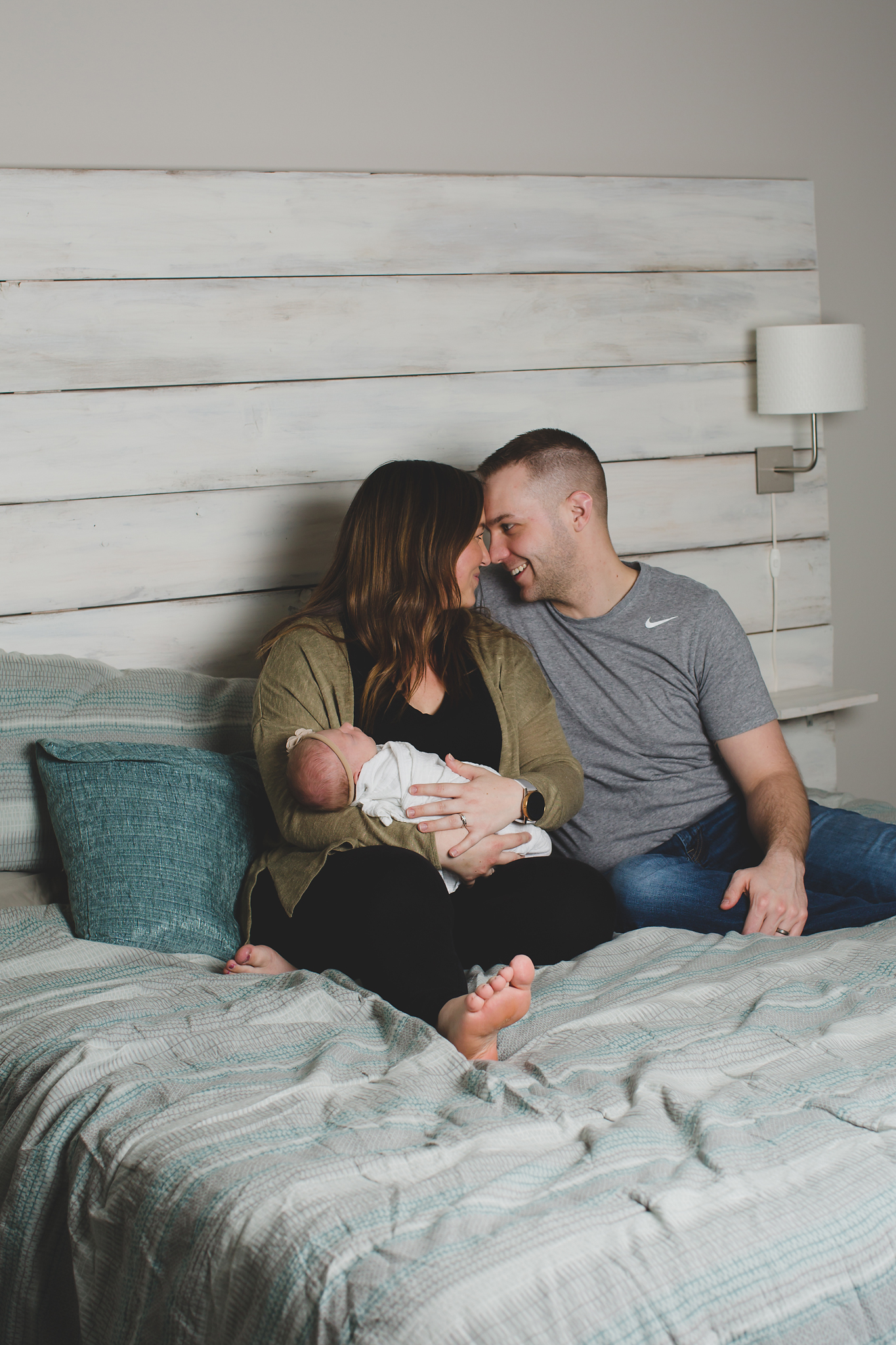 Baby Myla lifestyle newborn session at home with her parents on their bed